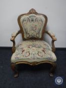 An early 20th century armchair in floral tapestry