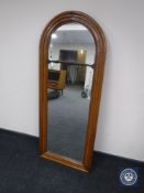 An antique walnut dome topped hall mirror