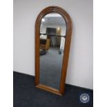 An antique walnut dome topped hall mirror