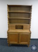 A set of continental oak bookshelves fitted cupboards and shelves