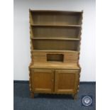 A set of continental oak bookshelves fitted cupboards and shelves