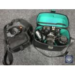 A Nikon Nikkormat camera with lens in bag together with a Nikon F-301 camera with lenses in case.