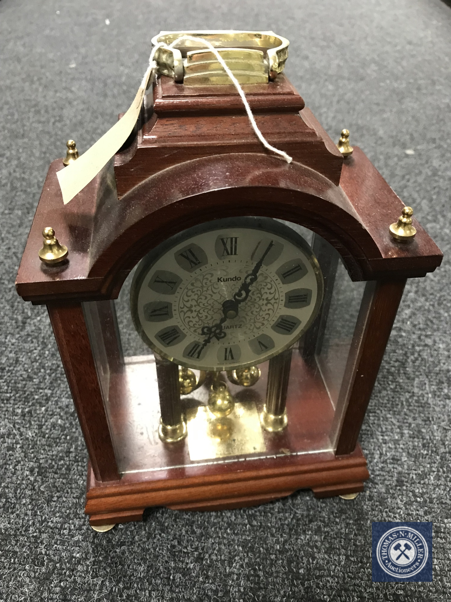 A Kundo quartz mantel clock CONDITION REPORT: Generally in good condition though