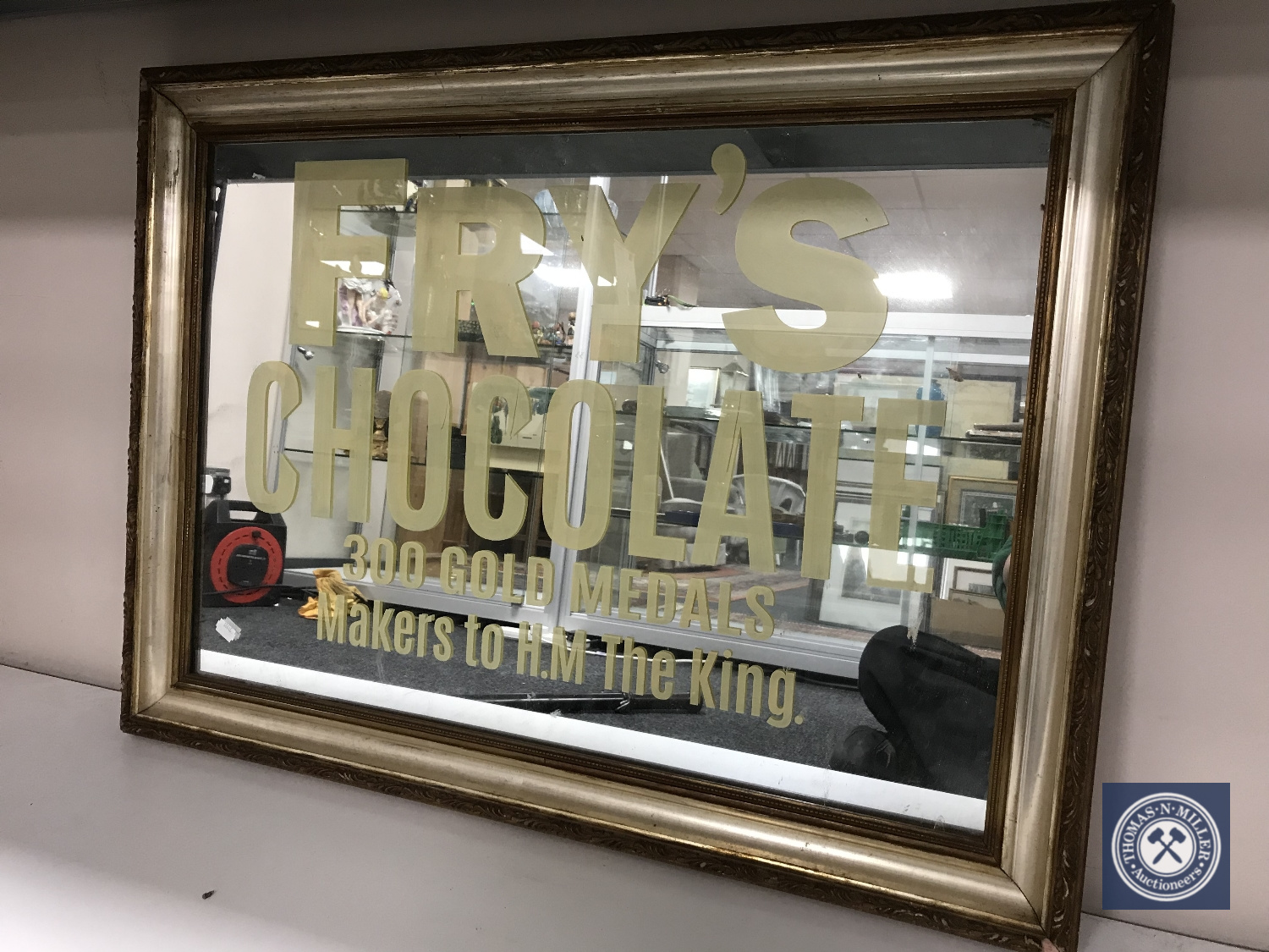 A gilt and silvered framed mirror bearing Fry's Chocolate advertisement