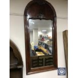 A late 19th century mahogany domed topped mirror