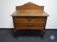 An early 20th century continental oak two-drawer table