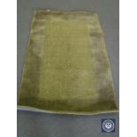 A hand tufted rug, jute loop cut green, 120 cm x 180 cm, rrp £297.00.