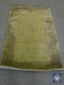 A hand tufted rug, jute loop cut green, 120 cm x 180 cm, rrp £297.00.