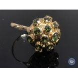A yellow gold peridot cluster ring, the shank indistinctly stamped 750.