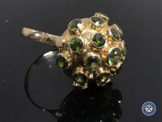 A yellow gold peridot cluster ring, the shank indistinctly stamped 750.