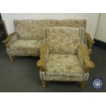 An oak framed three seater settee and armchair in floral tapestry fabric