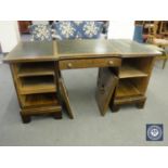 A continental oak and walnut twin pedestal desk fitted a drawer and cupboards with three tooled