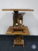 A pair of hardwood occasional table with elephant supports