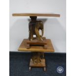 A pair of hardwood occasional table with elephant supports