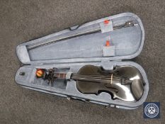 A black Stentor Harlequin violin and bow in a fitted case
