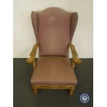 A continental oak wingback chair in pink fabric