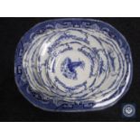 An antique Willow pattern meat dish together with seven assorted blue and white Delft plates