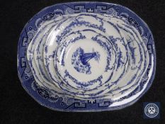 An antique Willow pattern meat dish together with seven assorted blue and white Delft plates