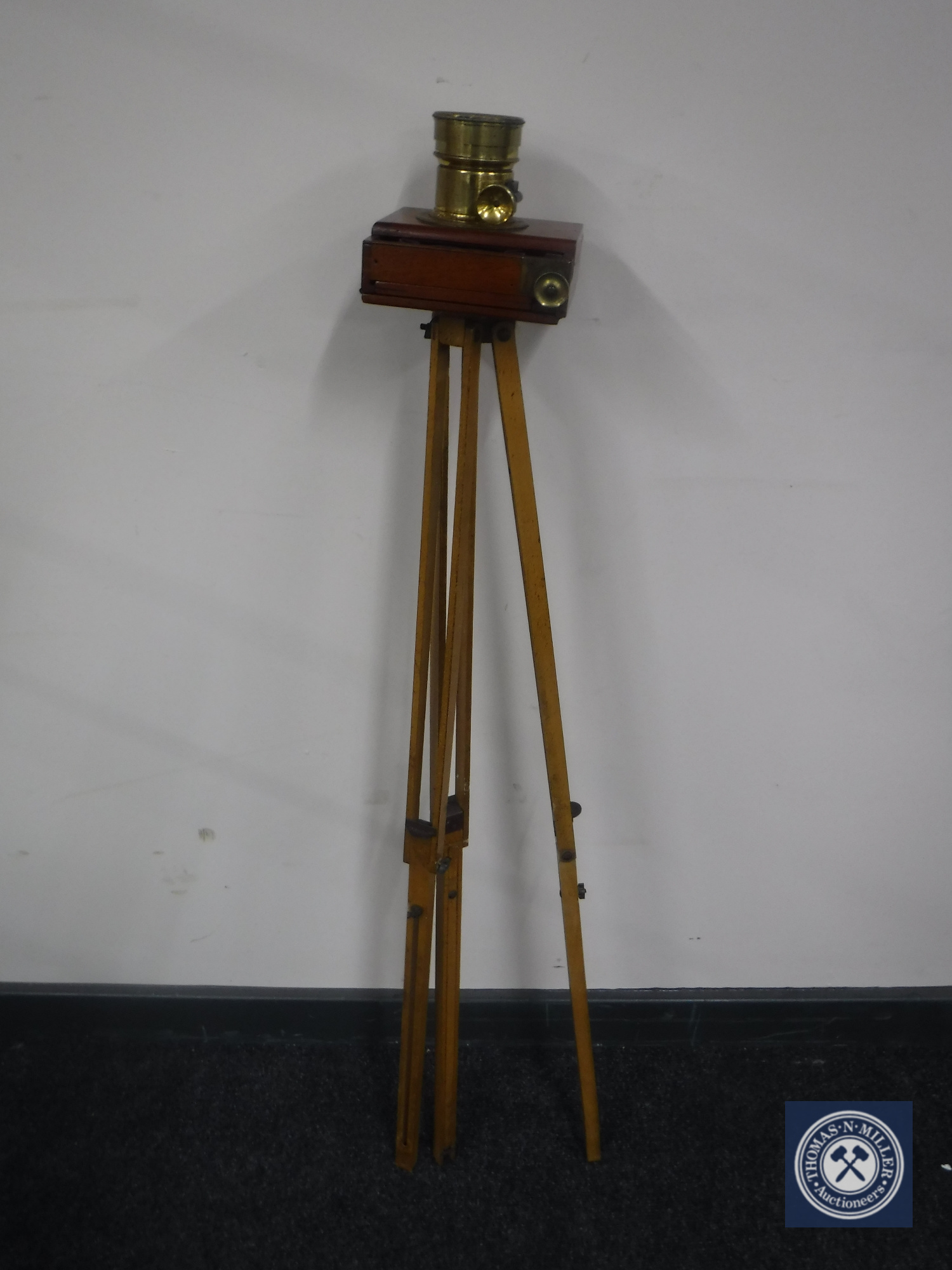 An early twentieth century mahogany and brass plate camera on tripod stand CONDITION