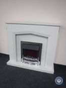 A chrome framed coal effect electric fire in surround