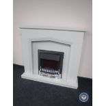 A chrome framed coal effect electric fire in surround