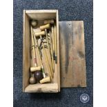 An early 20th century miniature croquet set in pine box