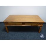 A pine coffee table fitted two drawers