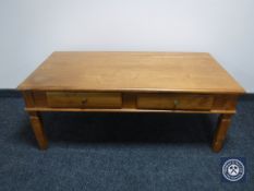 A pine coffee table fitted two drawers
