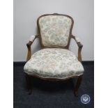 A continental armchair on cabriole legs in floral fabric