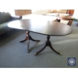 An oval mahogany twin pedestal table