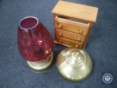 A miniature pine three-drawer chest together with a brass lidded urn and a brass oil lamp with