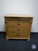 A 19th century pine four drawer chest on bun feet