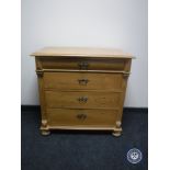 A 19th century pine four drawer chest on bun feet