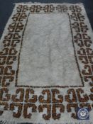 A 20th century fringed woollen rug