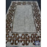 A 20th century fringed woollen rug