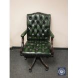 A green button leather high backed office chair.
