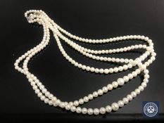 A cultured pearl three-strand necklace with silver,