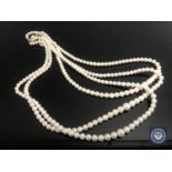 A cultured pearl three-strand necklace with silver,
