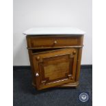 A continental oak marble topped cabinet