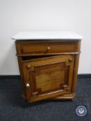 A continental oak marble topped cabinet