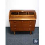 A mid 20th century barrel fronted bureau