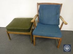 A mid 20th century teak armchair and odd footstool