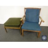 A mid 20th century teak armchair and odd footstool