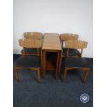 A melamine drop leaf kitchen table and four dining chairs