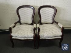 A pair of contemporary mahogany armchairs in white floral fabric