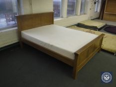 A contemporary oak 5' bed frame with Erogoflex Memory Foam kingsize mattress