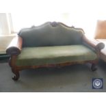 An antique continental mahogany framed settee in green fabric