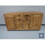 A contemporary mango wood sideboard