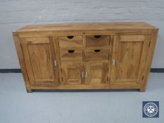 A contemporary mango wood sideboard