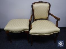 A continental style armchair and footstool in gold fabric